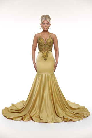 Gold evening gown with intricate detailing on a white background
