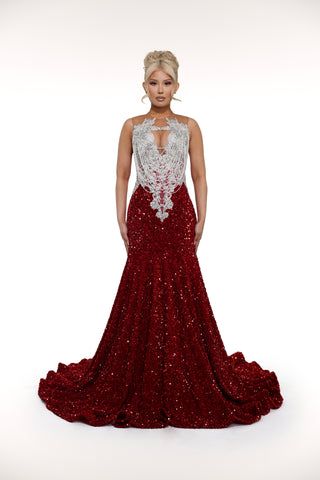 Red evening gown with silver embellishments on a white background