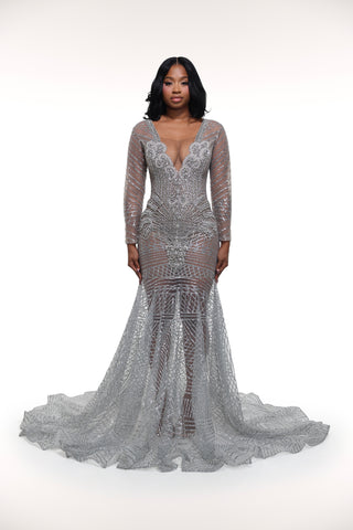 Woman wearing a silver sequin gown on a white background