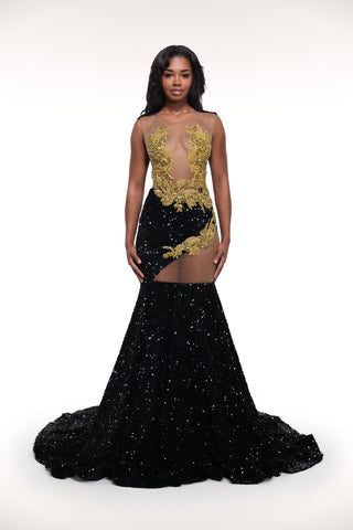 Black evening gown with gold embroidery on a white background