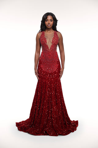 Woman wearing a red beaded evening gown on a white background