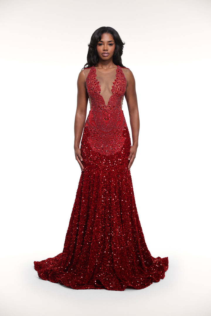 Woman wearing a red beaded evening gown on a white background